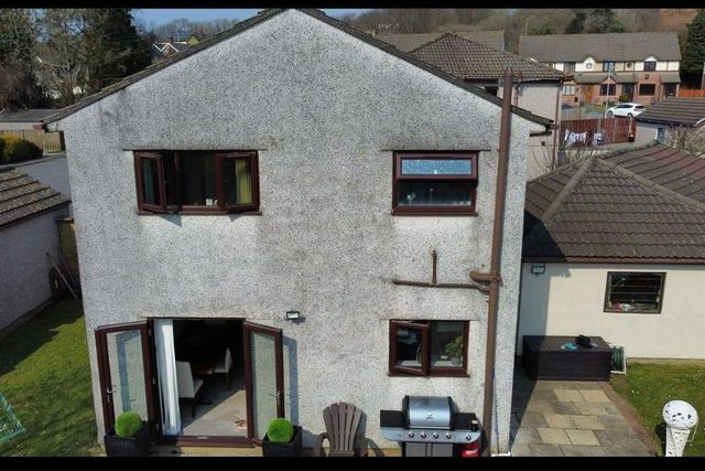 Before: Rear elevation: stained walls repaired and refinished